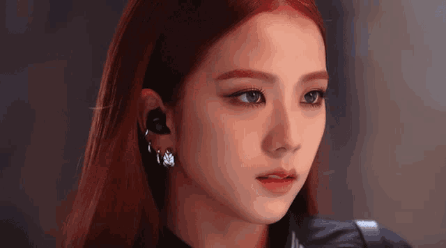 a close up of a woman wearing earrings
