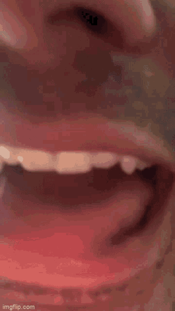 a close up of a person 's mouth with their tongue out