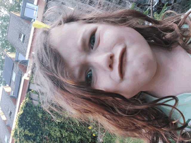 a young girl with red hair looks at the camera