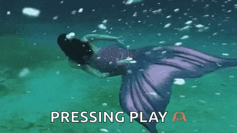 a mermaid is swimming in the ocean with the words pressing play behind her