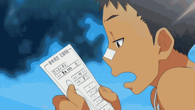 a boy with a bandage on his nose is holding a piece of paper with chinese writing on it