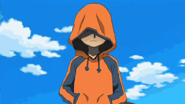 a boy in an orange hoodie stands in front of a blue sky with white clouds