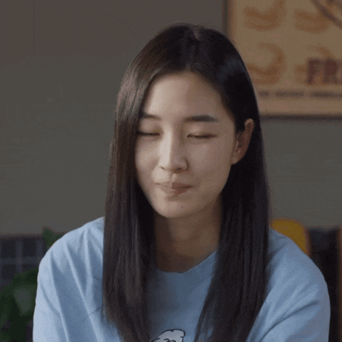 a woman in a blue shirt with a bear on it