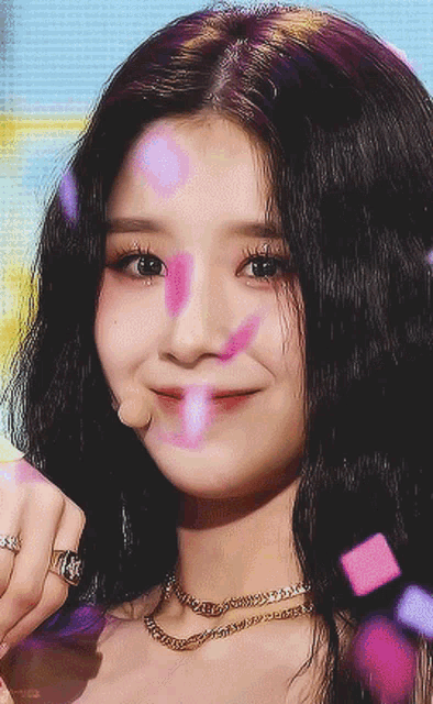 a close up of a woman 's face with a pink heart on her face