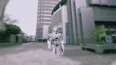 a cartoon character is standing in front of a large building