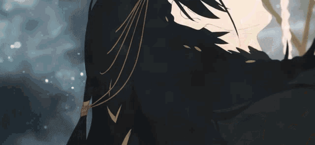 a close up of a person 's face with black hair and gold fringe