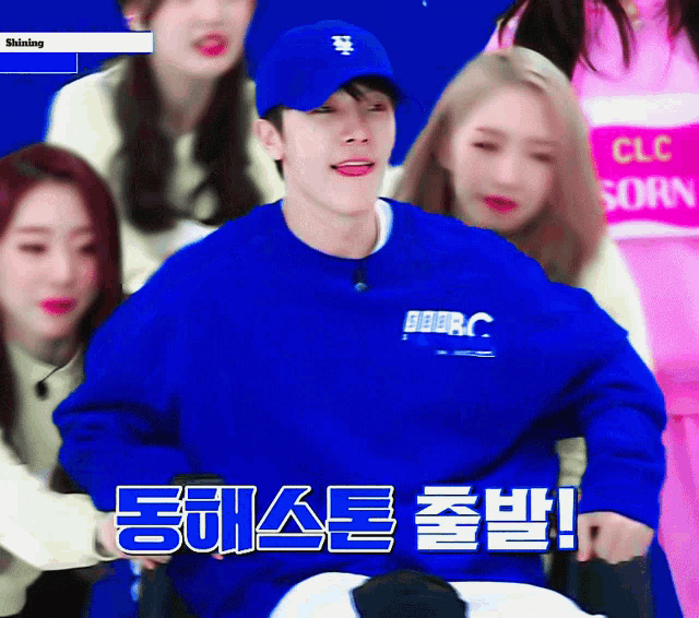 a man wearing a blue sweater with bbc on the front