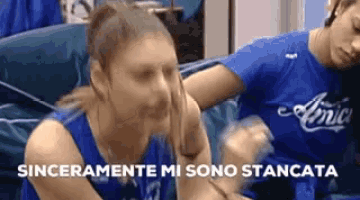 a woman wearing a blue shirt that says amici on it