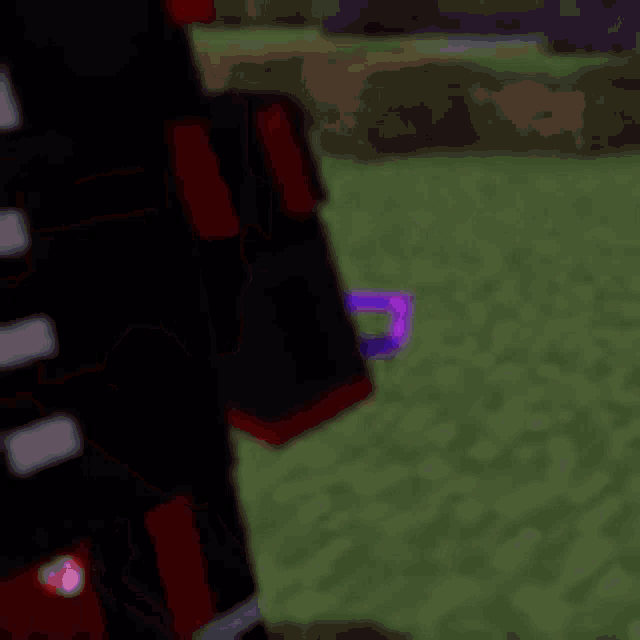 a close up of a person holding a purple sword in a video game .