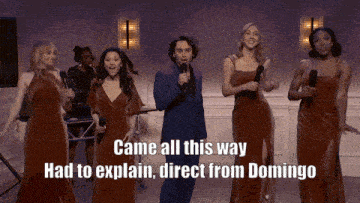 a man singing into a microphone with the words came all this way had to explain direct from domingo above him