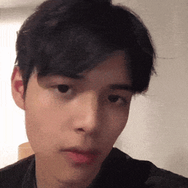 a close up of a person 's face with a serious look on his face