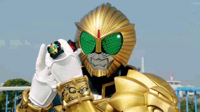 a person in a gold and green costume with the letter c on their arm