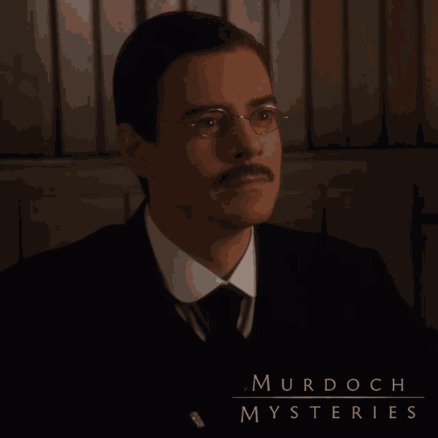 murdoch mysteries poster showing a man with glasses and mustache