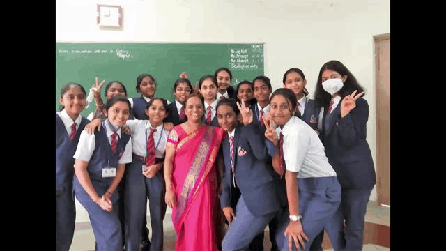 a group of girls posing for a picture with a teacher