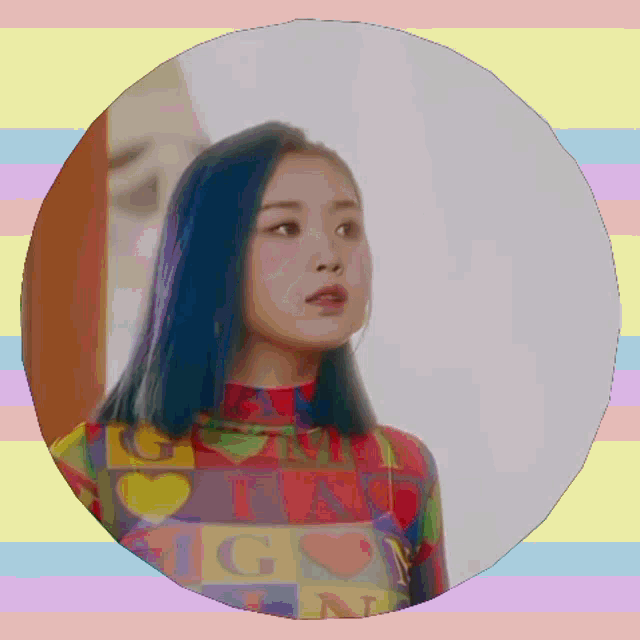 a girl with blue hair is wearing a colorful shirt with the letters ig on it