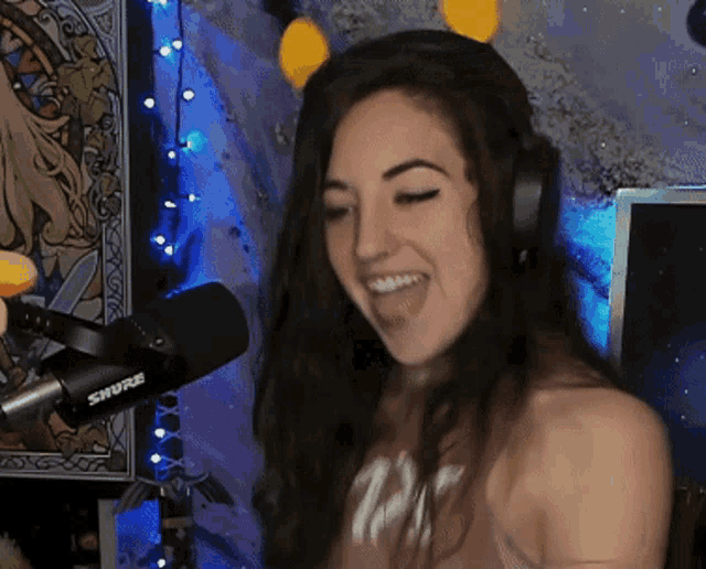 a woman wearing headphones and a shirt with the number 12 on it