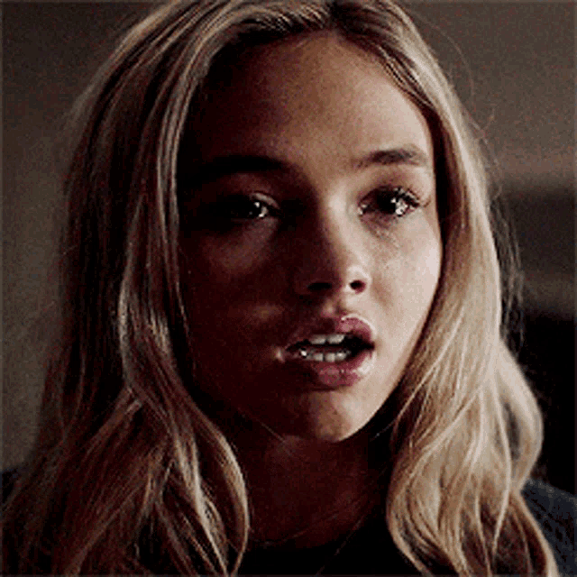 a close up of a woman with her mouth open