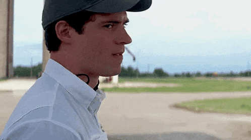 a man wearing a baseball cap and white shirt