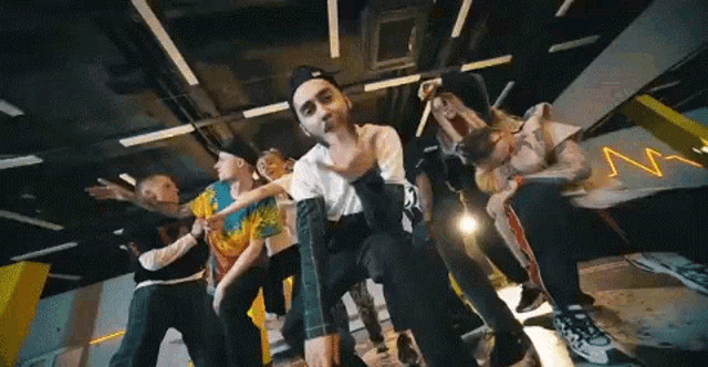 a group of young people are dancing together in a dance studio .