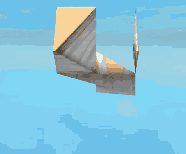 a computer generated image of a geometric shape with a blue sky in the background