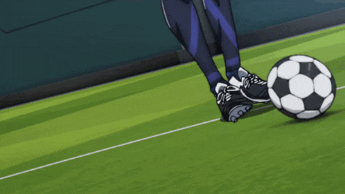 a person kicks a soccer ball on a green field