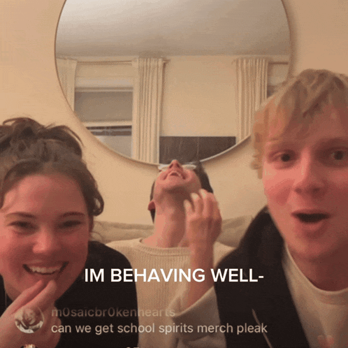 a group of people are standing in front of a mirror and the caption says im behaving well can we get school spirits merch pleak