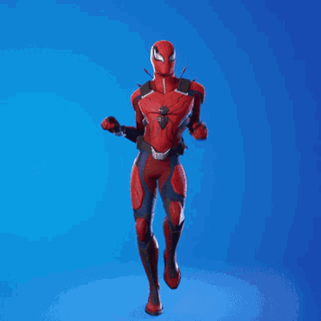 a man in a red and black spiderman costume is dancing on a blue background