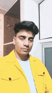 a man wearing a yellow jacket and a blue shirt