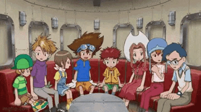 a group of digimon characters are sitting around a table in a room .
