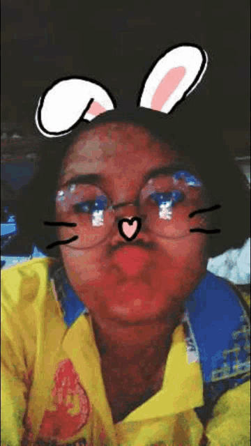 a girl wearing bunny ears and glasses is making a face