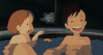 a boy and a girl are laughing in a hot tub