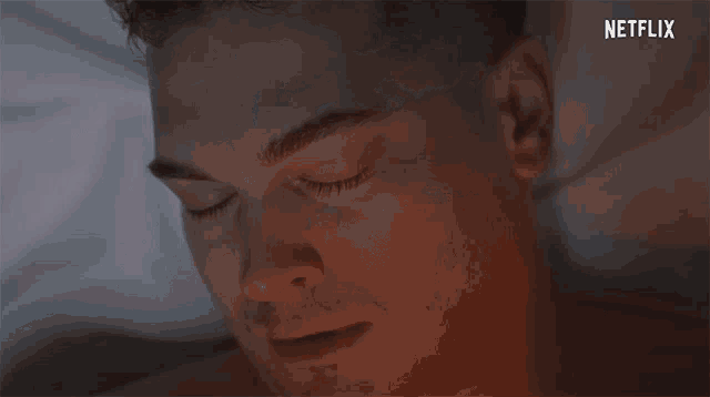 a close up of a man 's face with his mouth open and a netflix logo in the background .