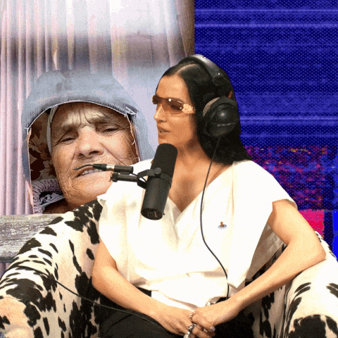 a woman wearing headphones sits next to a cow print chair