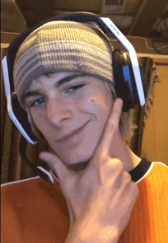 a young man wearing a beanie and headphones with the word evolve on the bottom