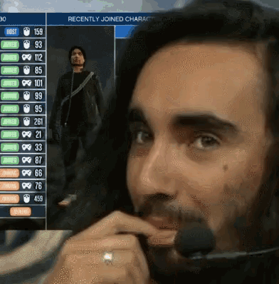 a man wearing a headset is looking at a screen that says recently joined character