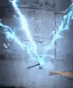 a person is holding a hammer and a lightning bolt is coming out of it .