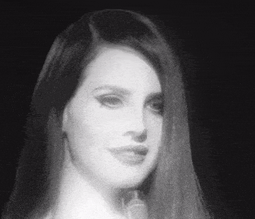 a woman with long hair is singing into a microphone .