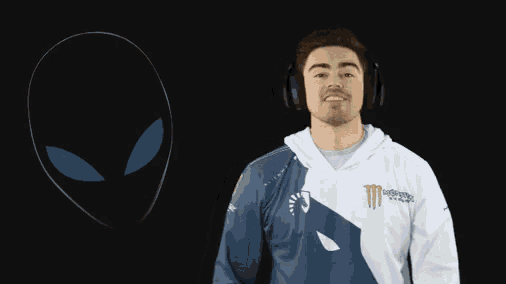 a man wearing headphones and a monster shirt