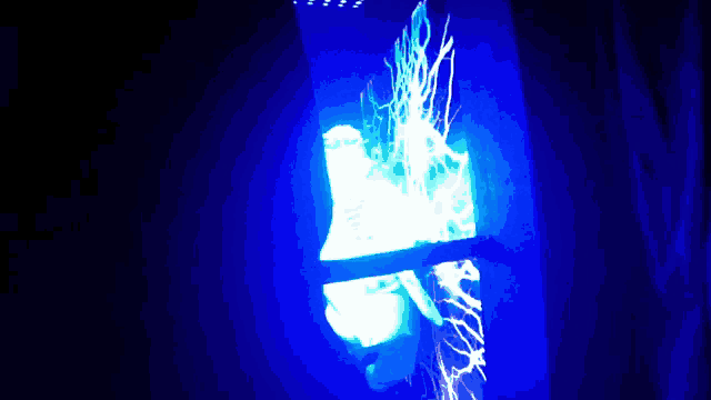 a blue light is shining in the dark