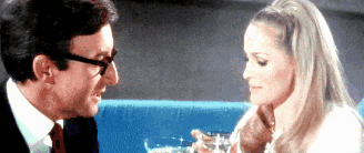 a man and a woman are sitting next to each other and drinking