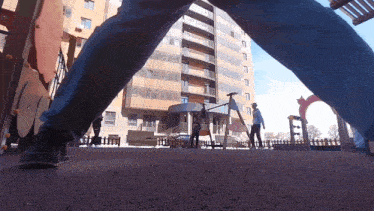a person standing in front of a building with the letter f on the ground