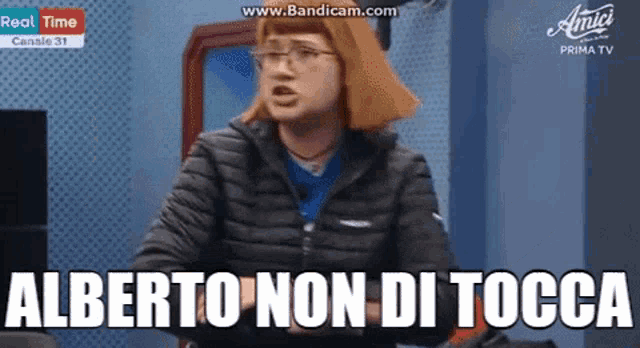 a woman with red hair and glasses is saying alberto non di tocca .