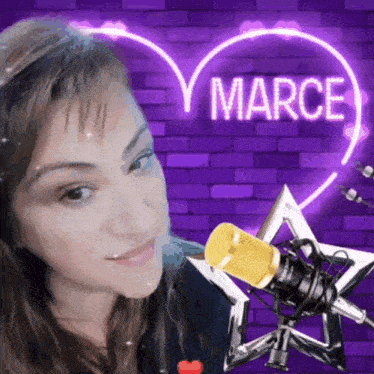 a woman is standing in front of a microphone with a neon heart that says marce