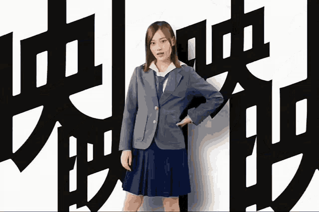 a girl in a school uniform is standing in front of a wall with chinese characters on it