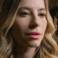 a close up of a woman 's face with blonde hair and pink lips .