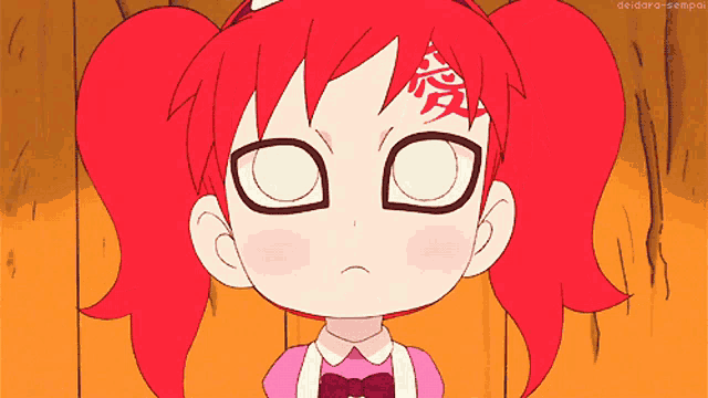 a little girl with red hair has a tattoo on her forehead that says " i love you "