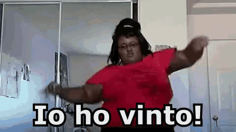 a woman in a red shirt is dancing in a room with the words `` io ho vinto '' written on the bottom .