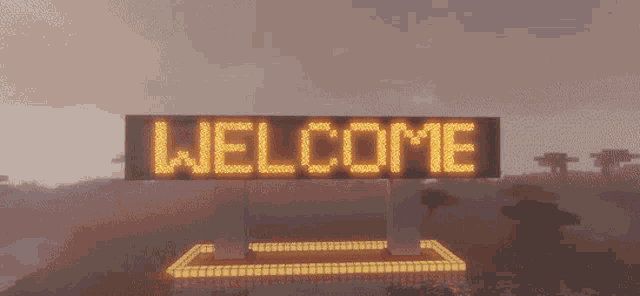 a sign that says welcome is lit up in yellow letters