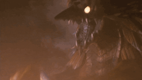 a close up of a dragon 's face with flames coming out of its mouth