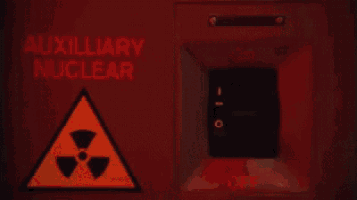 a person is pressing a button that says auxiliary nuclear on it